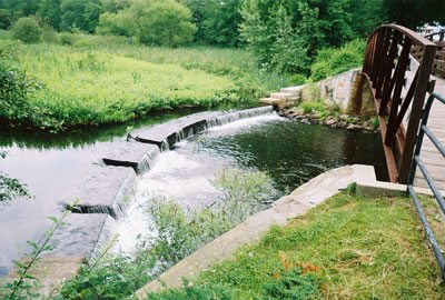 The Woonasquatucket River & Arching Footbridge at Esmond Park - Photo by Richard Mello (2004)